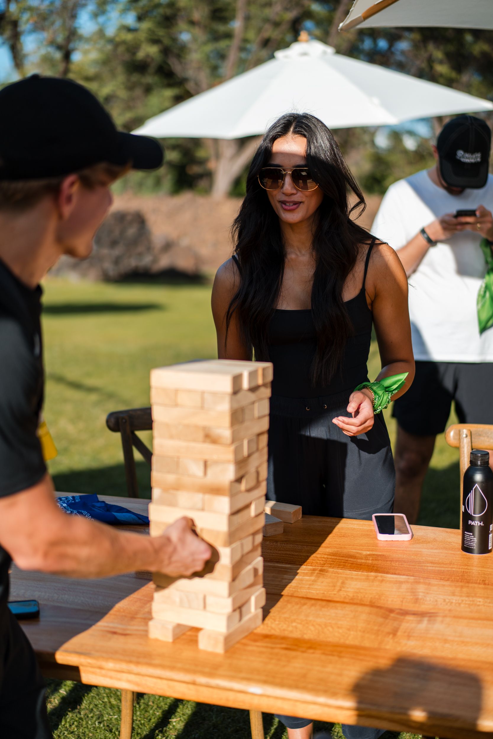 a woman playing a game of jenga with a man in a black hat