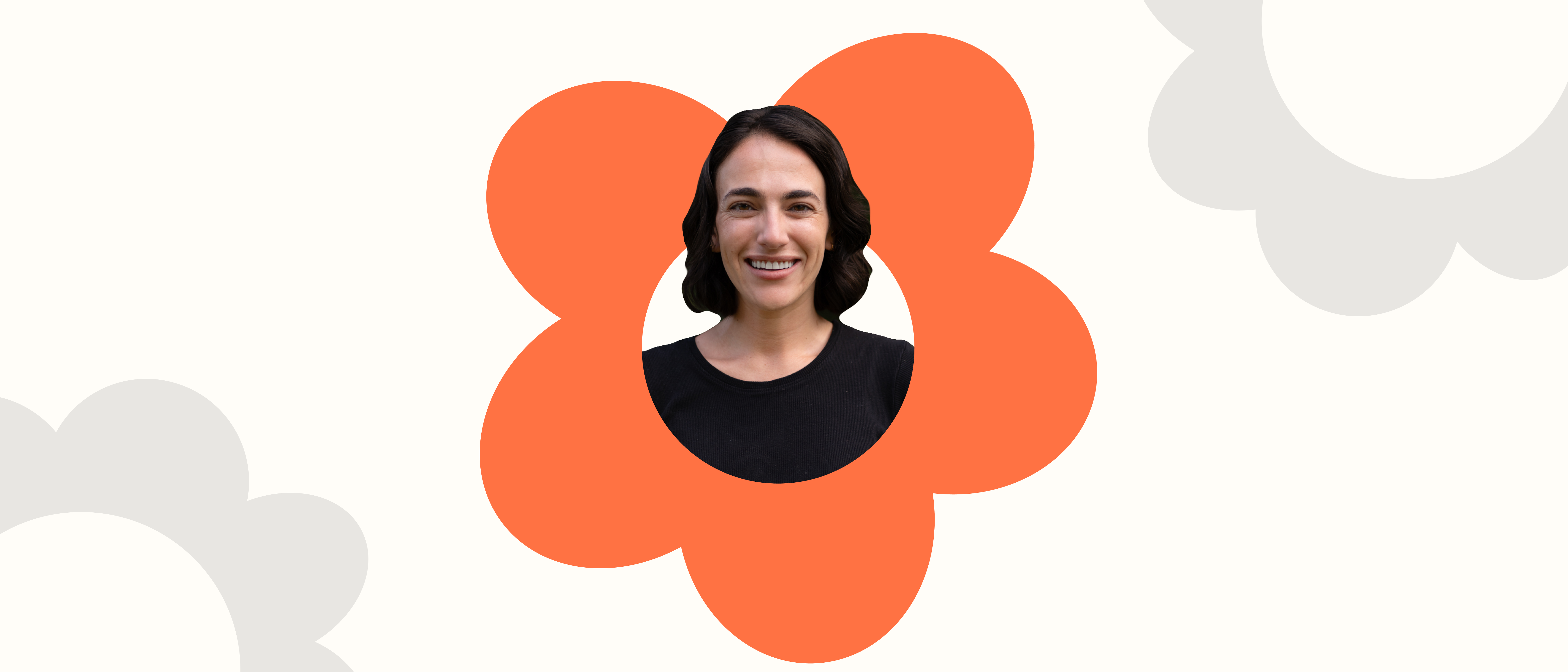 a woman in a black shirt is surrounded by an orange flower