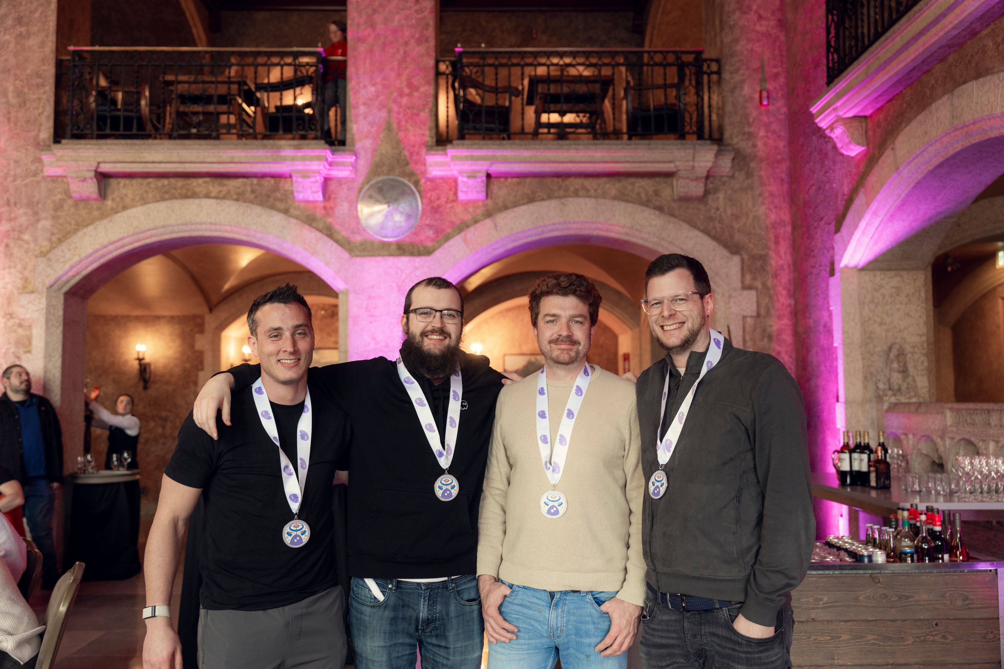 a group of men wearing medals are standing next to each other in a room .